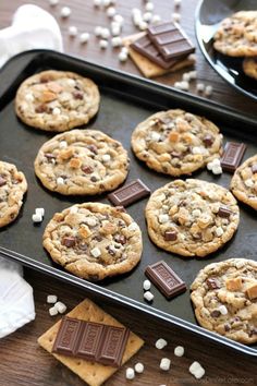 chocolate chip cookies and marshmallows on a baking sheet