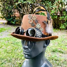 "This beautiful Steampunk Party Hat is made of 100% finest quality and hand-painted craftsmanship. Occasion: Great for Steampunk, Halloween, Music Festival, Burning Man, Masquerade Party, and more. Color: Brown Inside Measurement: Length: 8\" Width: 6.5\" Depth of Hat: 4.5\"" Steampunk Costume Accessories For Cosplay, Steampunk High Crown Costume Accessories For Festivals, Adjustable Novelty Mini Hat For Cosplay, Steampunk Brimmed Costume Hats For Themed Events, Steampunk Brimmed Hat For Themed Events, Steampunk Adjustable Costume Hats And Headpieces, Adjustable Steampunk Top Hat For Themed Events, Adjustable Brimmed Themed Costume Accessories, Themed Adjustable Top Hat For Costume