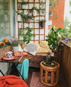 an outdoor patio with plants and potted plants on the wall, next to a couch