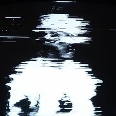 the reflection of a man's face in water