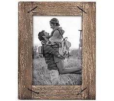 an old wooden frame with a man and woman kissing