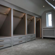 an empty room with some drawers and lights