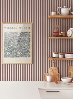 a kitchen with striped wallpaper and shelves filled with plates, bowls and utensils