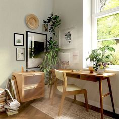 a wooden desk sitting next to a window in a room with white walls and wood flooring