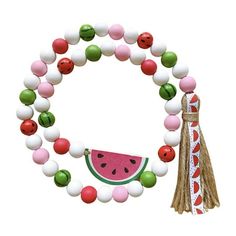 a watermelon and white beaded bracelet with tassels