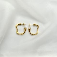 Pearl Hoop Earrings14K Gold Plated Stainless SteelOur Pearl Hoops are the perfect marriage of elegance and charm and will make a delightful addition to any jewelry collection. This lightweight accessory is minimalist in make, yet timeless in style. The unique pair is made with 14K Gold Plated Stainless Steel allowing its color to remain over time. It is accented with pearl impression.All of our products are lightweight and made with hypoallergenic materials to allow for comfortable, all day wear Gold-plated Hoop Earrings With Pearl Drop For Anniversary, Gold Plated Hoop Earrings With Pearl Drop For Anniversary, Timeless Gold-plated Hoop Earrings For Weddings, Minimalist Hoop Pearl Earrings For Formal Occasions, Elegant Brass Huggie Earrings As Gift, Elegant Brass Huggie Earrings For Gift, Elegant Small Hoop Huggie Earrings In Brass, Modern Hoop Earrings For Wedding, Gold Plated Hoop Earrings For Wedding