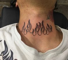 a man with a tattoo on his neck that has flames coming out of the back