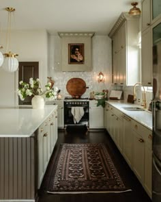 a kitchen with an oven, sink and rug on the floor in front of it