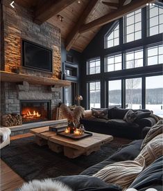 a living room filled with furniture and a fire place in front of a large window