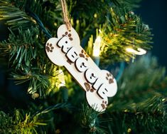 a dog bone ornament hanging from a christmas tree with the word rescue written on it