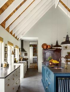 a large kitchen with an island in the middle and lots of counter space on one side