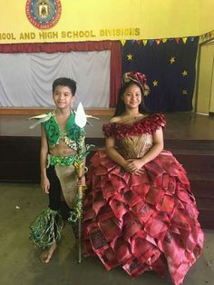 two children dressed up in costumes standing next to each other at a school assembly event