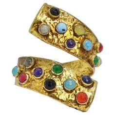 Elevate your style with this 1970s Brass Multicolor Gemstone Cuff Bracelet. This incredible cuff boasts an abstract, wraparound motif crafted from textured brass and adorned with a striking array of multicolor gemstones. With its eye-catching design and modern flair, it's the perfect vibrant accessory to add a touch of elegance and color to your look. Transport yourself to the 1970s with this exquisite bracelet that captures the essence of the era's chic style. The textured brass adds depth and 1970s Accessories, Hammered Cuff Bracelet, Gemstone Cuff Bracelet, Multicolor Bracelet, Diamond Cuff Bracelet, Vintage Cuff Bracelet, Turquoise Bracelet Cuff, Bracelets Gold Diamond, Aztec Designs