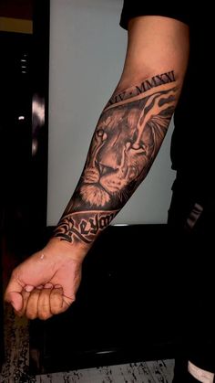 a man with a lion tattoo on his arm