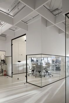 an office with glass walls and white floors