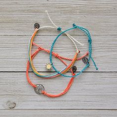 This Set From Pura Vida Comes With Three Bracelets; A Turquoise Mini Braided Bracelet With A Silver + Yellow Sun Charm, An Orange Multi-String Bracelet With An Antique Silver Palm Tree Charm, And A Classic Pura Vida String Bracelet In Vibrant Summertime Colors. Nwot: The Item Is In Perfect Condition - 100% Waterproof - Wax Coated - Adjustable From 2-5 Inches In Diameter Please Reach Out With Any Questions On This Item! . Bundle + Save! Enjoy 15% Off When You Purchase Two Or More Items From My Cl Pura Vida Charm Bracelets, Summertime Athleisure, Cute Pura Vida Bracelets, Pura Vida Bracelets Aesthetic, Pura Vida Bracelets Diy, Slay Bracelets, Beachy Jewelry Pura Vida, Pura Vida Bracelets Set, Yellow Pura Vida Bracelet