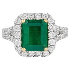 Classic emerald and diamond halo ring, GIA certified.  2.76 carats total gemstone weight. 1.85 carat emerald cut emerald, F2, GIA certified. Complimented by 50 round brilliant diamonds, 0.91 carats, F/G color and VS clarity. 18k white and yellow gold, 6.17 grams, current ring size 6.5.  Accommodated with an up to date digital appraisal by a GIA G.G., once purchased, upon request. Please contact us with any questions. Thank you. Item Number R6789 Colombian Emerald Ring, Emerald Necklace Pendant, Statement Rings Diamond, Emerald Ring Gold, Round Diamond Setting, Modern Engagement Rings, White Gold Sapphire, Diamond Halo Ring, Gold Statement Ring