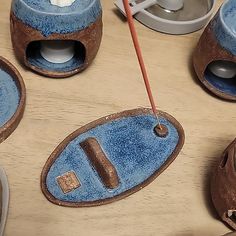 a wooden table topped with blue and brown items