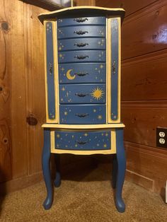 a blue and yellow dresser with stars on it