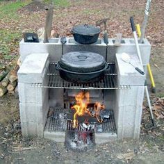 an outdoor grill with pots and pans on it