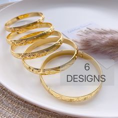 "Beautifully designed and easy to wear, this bangle is the ideal accessory to add to your jewelry collection. The bracelet has Beautiful design. 18k gold plated.  Size:  Diameter 2.4\"   available 6 Design/pattern  High Quality and you will love them These are made of high quality materials 18K gold plated and it will NOT tarnish nor discolor for a long time. High quality gold plated jewelry is a great alternative to solid gold jewelry.  very affordable price. This item is hypoallergenic so it won't irritate sensitive skin. Suitable for all occasions 🦋Jewelry Care:  As with all pieces that are not real gold, it is advised that you take proper jewelry care by not exposing to any harsh chemicals. This quality is excellent & can at least more than a year as long as there is proper care. 🌸Se Gold Bracelet With Simple Design As Gift, Gold Bracelet With Simple Design For Gift, Simple Gold Bracelet Gift, Simple Design Gold Bracelet As Gift, Simple Gold Bangle As A Gift, Gold Bangle With Simple Design As Gift, Gold Bracelets With Simple Design For Gift, Gold Tarnish-resistant Round Bangle, Gold Bangle Bracelet With Simple Design