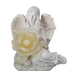 an angel statue with a flower in its hand