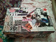 an open suitcase sitting on top of a bed covered in lots of stickers and pictures