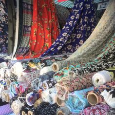 many different types of scarves are on display