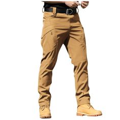 a man standing with his hands on his hips wearing brown pants and yellow shoes,