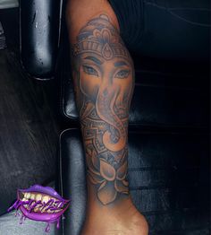 an elephant tattoo on the leg of a person with purple shoes next to it,