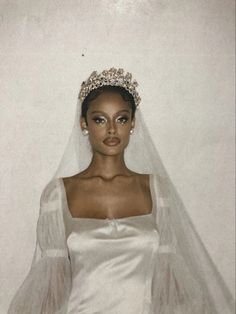 a woman wearing a wedding dress and veil