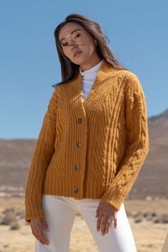 Wrap yourself in the timeless warmth of the Kara Short Cable Knit Cardigan, crafted from luxurious 100% Baby Alpaca. With its intricate cable pattern and versatile design, this cardigan adds a layer of cozy sophistication to any wardrobe. Available in natural tones and a bold vibrant hue, it’s the perfect piece to elevate both casual and polished looks. - Made from 100% ultra-soft Baby Alpaca for unmatched comfort and warmth.- Timeless cable-knit design that exudes classic elegance.- Available i Cable Knit Merino Wool Outerwear For Layering, Merino Wool Cable Knit Outerwear For Layering, Cable Knit Merino Wool Cardigan, Cozy Merino Wool Cable Knit Cardigan, Merino Wool Cable Knit Cardigan For Layering, Wool Cable Knit Cardigan For Layering, Cozy Merino Wool Cable Knit Outerwear, Long Sleeve Merino Wool Cable Knit Sweater Coat, Merino Wool Cable Knit Long Sleeve Cardigan