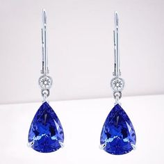 Elevate your elegance with these stunning earrings, featuring a dazzling pear-cut AAAA tanzanite. The vibrant, deep blue-violet tanzanite is meticulously prong-set to showcase its exceptional brilliance. Complementing the tanzanite are bezel-set moissanites, adding an extra layer of sparkle and sophistication. Set in luxurious 14k solid yellow gold, the lever back design ensures both security and comfort. The warm, golden hue of the metal beautifully contrasts with the cool, radiant tones of the Luxury Tanzanite Teardrop Earrings, Tanzanite Jewelry, Tanzanite Earrings, Blue Violet, Stunning Earrings, Pear Cut, Solid Yellow, The Cool, Prong Setting