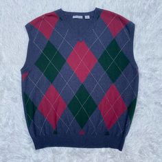 Brand New 100% Cashmere Argyle Patterned Men’s Sweater Vest In Perfect Condition, Size Xxl. Brand Is American Blue. Original Tags Attached, Unworn. No Flaws Or Imperfections! Dark Navy Blue With Red And Green Argyle Pattern On The Front. Classic Sweater Vest! Can Be Worn Casually, Can Be Dressed Up, Can Be Dressed Down. Perfect Sweater For The Fall/ Winter/ Holiday Months High-Quality Material And Extremely Soft. Sleeveless. V Neck. Pit To Pit- 24.5” Length- 28.5” From A Smoke Free Home. Offers Winter V-neck Argyle Pattern Top, Classic Blue Winter Sweater Vest, Classic Blue Sweater Vest For Winter, Cashmere Sweater Men, Argyle Sweater Vest, Perfect Sweater, Mens Cashmere, Henley Sweater, Navy Blue Sweater