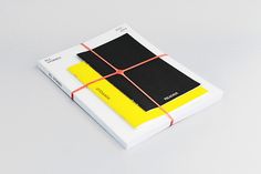 a white book with yellow and black squares on it