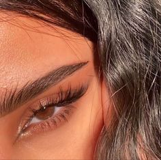 a close up of a woman's eye and hair