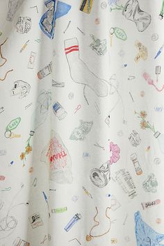 a white curtain with drawings on it