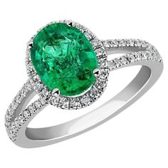 Prepare to be amazed by the sheer beauty of the 2.5 Carat Oval Natural Zambian Emerald & 2 ct of Diamond Ring, a true masterpiece crafted in exquisite 14 Karat White Gold. This extraordinary ring showcases a magnificent natural Zambian emerald, flawlessly cut to perfection, weighing approximately 2.5 carats. The emerald exudes exceptional quality and radiance, captivating all with its enchanting allure. Surrounding the center stone, you'll find approximately 2 carats of round diamonds, intricately encircling the emerald and gracing two bands that are elegantly brought together to enhance the ring's aesthetic appeal. These dazzling diamonds elevate the overall beauty and glamour of the ring, creating a mesmerizing display of sparkle and brilliance. One can't help but appreciate the impeccab Exquisite Oval Brilliant-cut Gemstones, Exquisite Oval Brilliant Cut Gemstones, Classic Oval Gemstones With Halo Setting, Dazzling Oval Emerald Ring In Platinum, Elegant Oval Gia Certified Gemstones, Oval Brilliant Cut Dazzling Gemstones, Dazzling Oval Brilliant Cut Gemstones, Dazzling Oval Gemstones With Brilliant Cut, Oval Brilliant Cut Emerald Gemstones