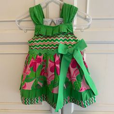 Super Cute And Colorful Sundress. Wide Straps. Tiered Skirt. Green Rickrack Waist Trim. Green Grosgrain Ribbon Bow. Keyhole Back With Button Loop Close. 100% Cotton. Machine Wash. New And Never Worn. Pet And Smoke Free Home. Ls70145 Playful Ruffle Twirl Dress For Play, Playful Ruffled Twirl Dress For Play, Cute Green Ruffled Dresses, Cute Green Dresses With Ruffles, Playful Ruffled Dresses For Holidays, Playful Holiday Dresses With Ruffles, Playful Ruffled Holiday Dresses, Pink Twirl Dress With Ruffle Hem For Playtime, Pink Cotton Twirl Dress With Ruffle Hem