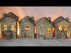 three small houses are lit up in the snow