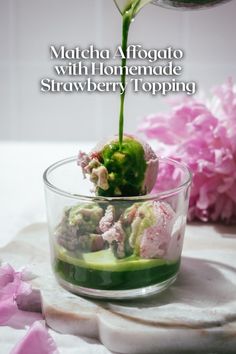 a glass bowl filled with cucumbers and flowers on top of a white table cloth