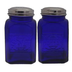 two blue glass jars with metal lids