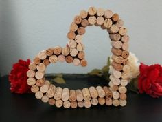 a heart made out of wine corks on a table