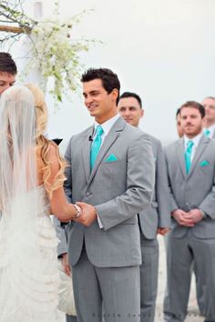 a man and woman standing next to each other in front of a group of people