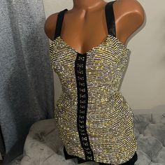 a mannequin wearing a black and yellow dress