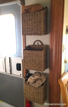 three wicker baskets are hanging on the wall