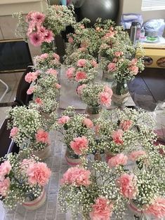 flowers are arranged in vases on a table