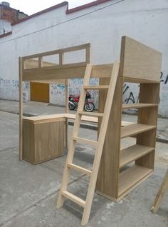 a wooden bunk bed sitting next to a wall