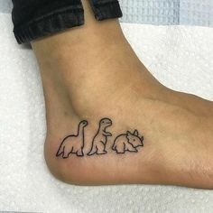 a person with a tattoo on their foot that has three cats and a dog in it