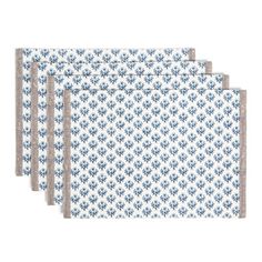 four placemats with blue and white designs on them, one is folded up